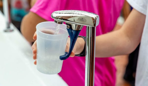 people refilling water cup at event