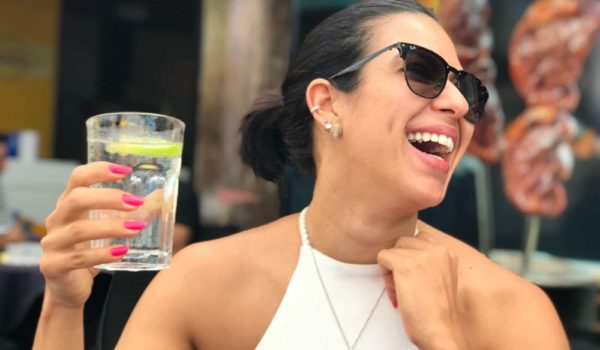woman holding cup of water