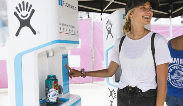 woman at water refill station in us open surfing