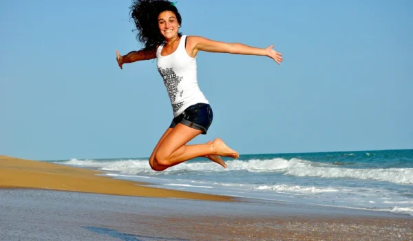 woman jumping on beach