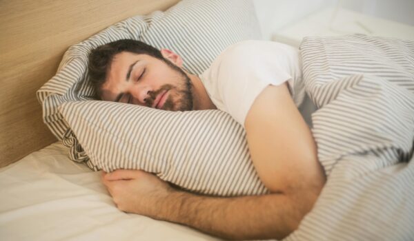 man sleeping in bed