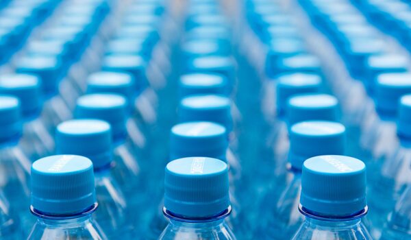 rows of plastic bottles with blue caps