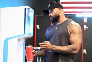 muscular man refilling water bottle with FloWater Refill Station