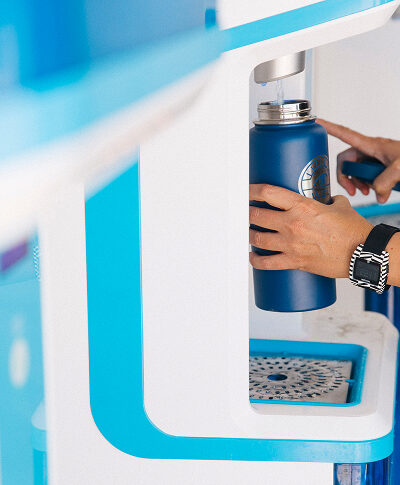 refilling water bottle at a row of flowater refill stations