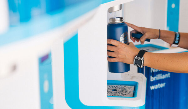 refilling water bottle at a row of flowater refill stations