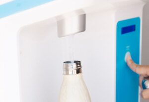 white water bottle being filled with Flowater refill station