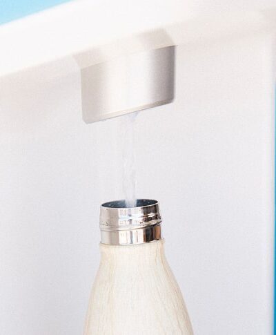 white water bottle being filled with Flowater refill station