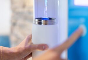 white water bottle being refilled with flowater