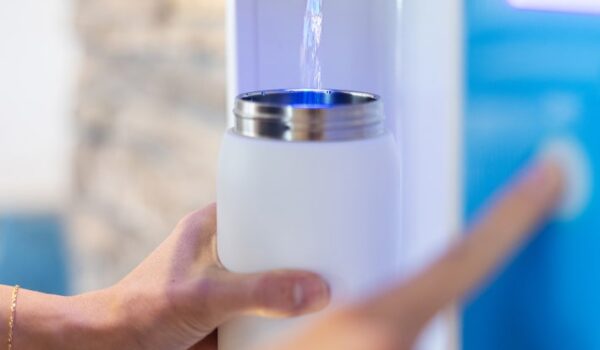 white water bottle being refilled with flowater