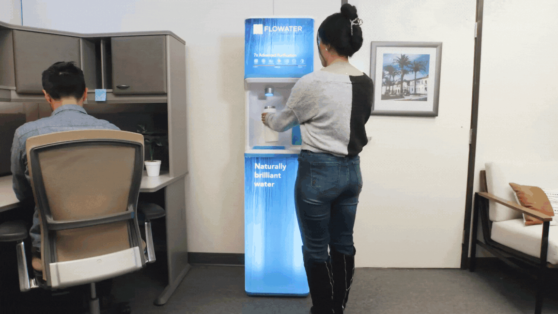 businesspeople using flowater refill station