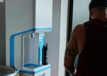 white flowater refill station refilling a water bottle