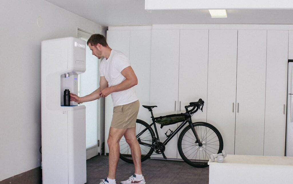 guy using refill station in his garage
